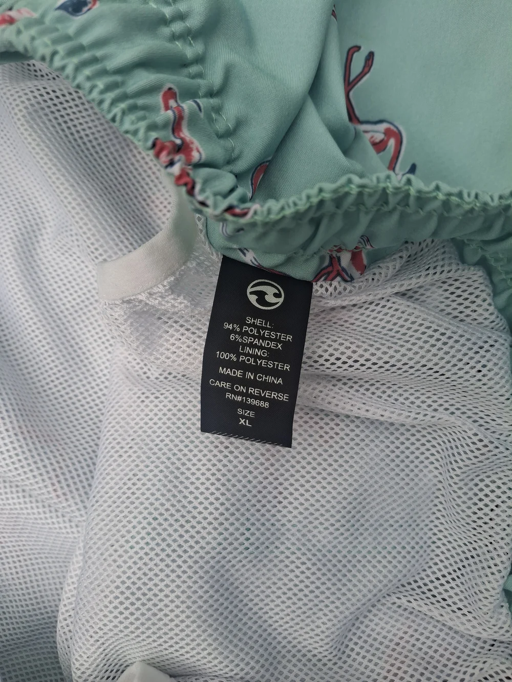 Ocean Current Mint Green Swim Trunks with Pink Flamingo Print